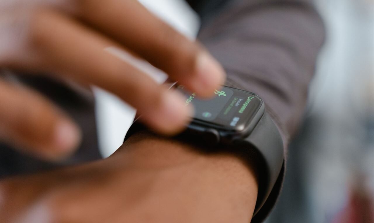 A detailed image showing a person interacting with a smartwatch, highlighting fitness tracking capabilities.